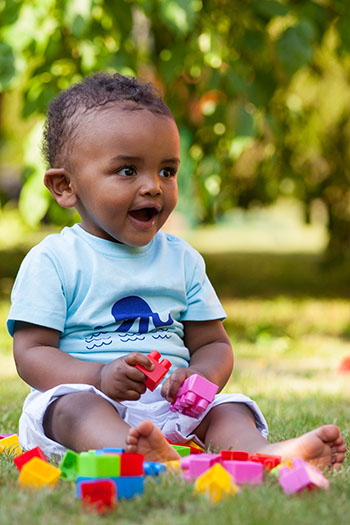 Smiling Toddler with Blocks at the Pediatric Dentist in Tucson, Dr. Michael LaCorte